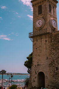 Low angle view of clock tower against clear sky