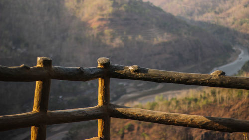 Close-up of fence against mountain