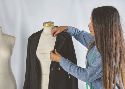 Rear view of woman standing against white background