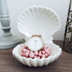 Close-up of wristwatch and decoration on table