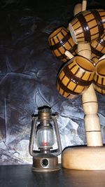 Close-up of lantern on table against wall