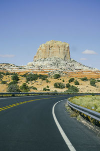 Empty road leading towards mountains