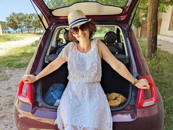 Portrait of smiling young woman in car