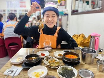 Portrait of smiling woman having food at restaurant
