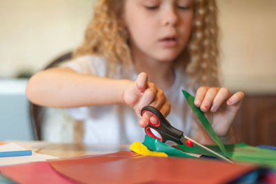 Midsection of woman holding toy while sitting on table