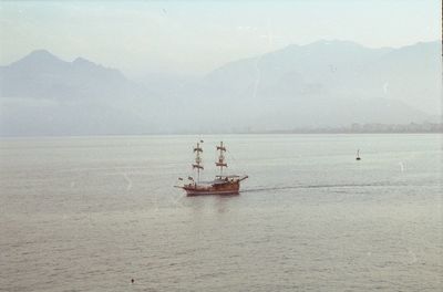 Boat sailing on sea against sky