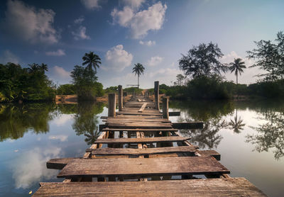Gazebo by lake against sky