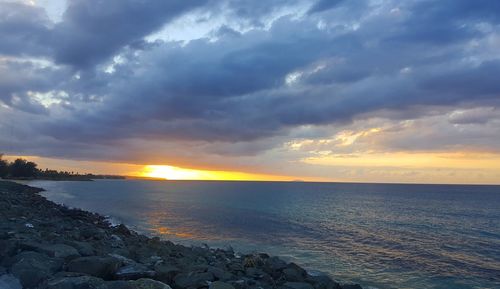 Scenic view of sea against dramatic sky