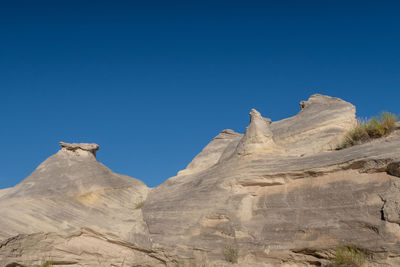 Landscape of solid grey rock formation with small hoodoos at grand staircase escalante in utah