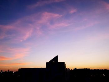 Low angle view of silhouette city against sky during sunset