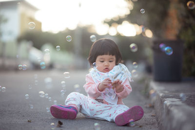 Girl sitting outdoors