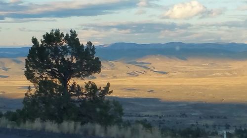 Scenic view of mountains against cloudy sky