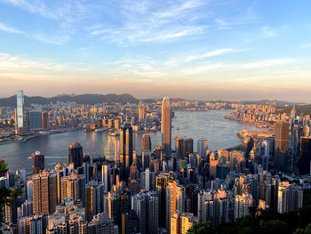 Aerial view of buildings in city during sunset