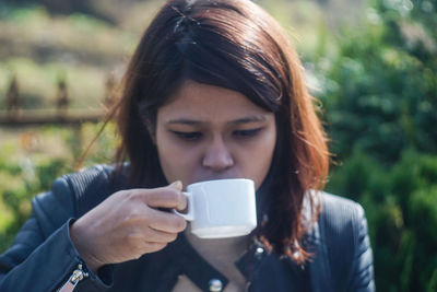 Young woman using smart phone in city