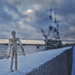 Man standing by sea against sky during winter