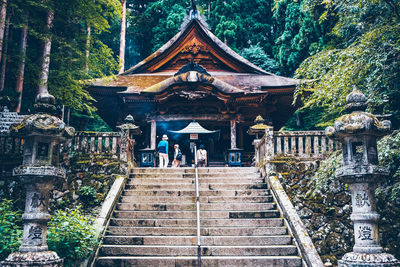 People outside temple by building