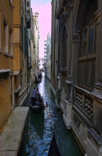 Venice, italy vertical wide angle view of the city of venice, narrow canal and gondola with tourists