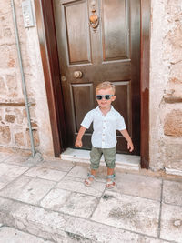 Full length of boy standing by door