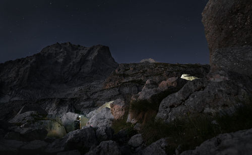 Low angle view of rock formations against sky at night, abruzzo italy