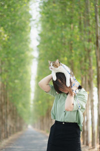 Asian woman happy during travel and play with her cat on spring season
