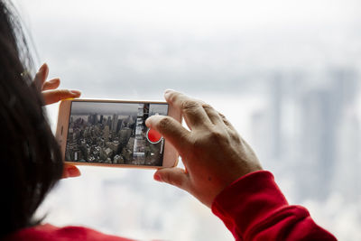 Close-up of woman photographing cityscape