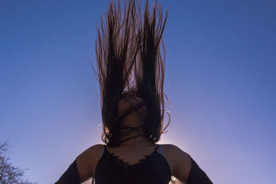 Rear view of woman against sky