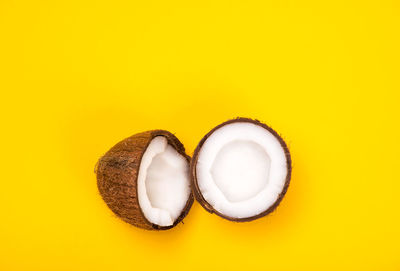 Directly above shot of eggs against yellow background