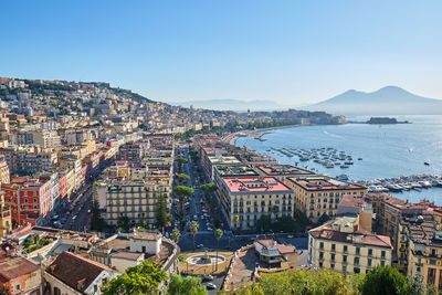 High angle view of buildings and sea against sky