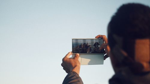 Rear view of man photographing