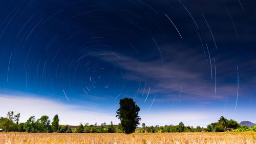 Lightning over field against sky at night