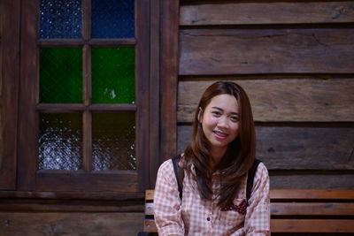 Portrait of woman sitting on bench