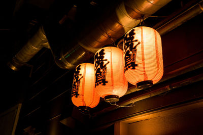 Low angle view of illuminated lanterns hanging on ceiling