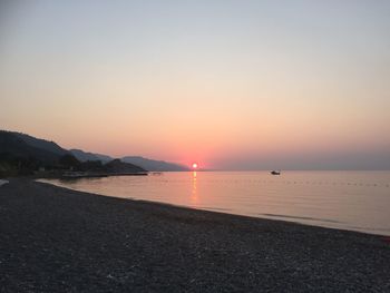 Scenic view of sea against clear sky during sunset