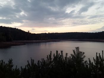 Scenic view of lake against sky at sunset