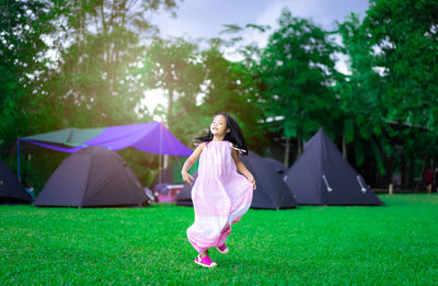 Rear view of woman with umbrella on field