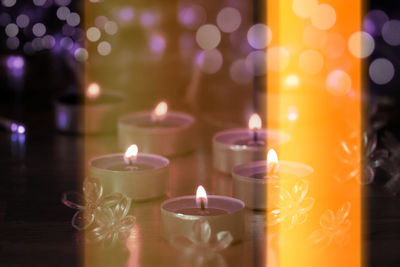 Close-up of lit tea light candles in temple