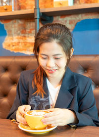 Portrait of a young woman with coffee