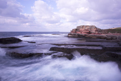 Scenic view of sea against cloudy sky