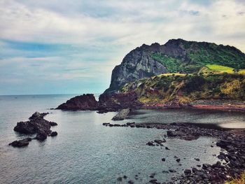 Rock formations in sea against sky