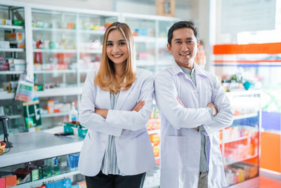 Portrait of young woman standing in laboratory