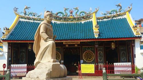 Statue of temple against building