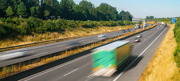 Blurred motion of highway against trees