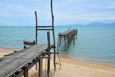 Pier over beach against sky