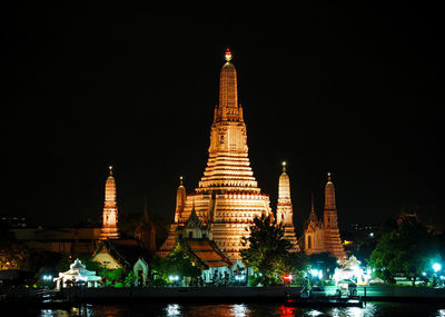 Illuminated temple against sky at night