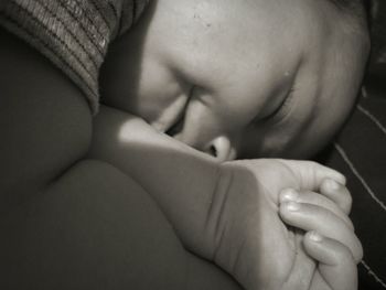 Close-up of baby sleeping on bed at home