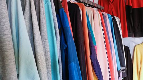 Full frame shot of multi colored clothes hanging in store