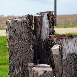 Close-up of wooden post against sky