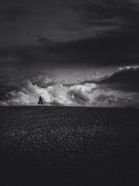 Silhouette of people against cloudy sky