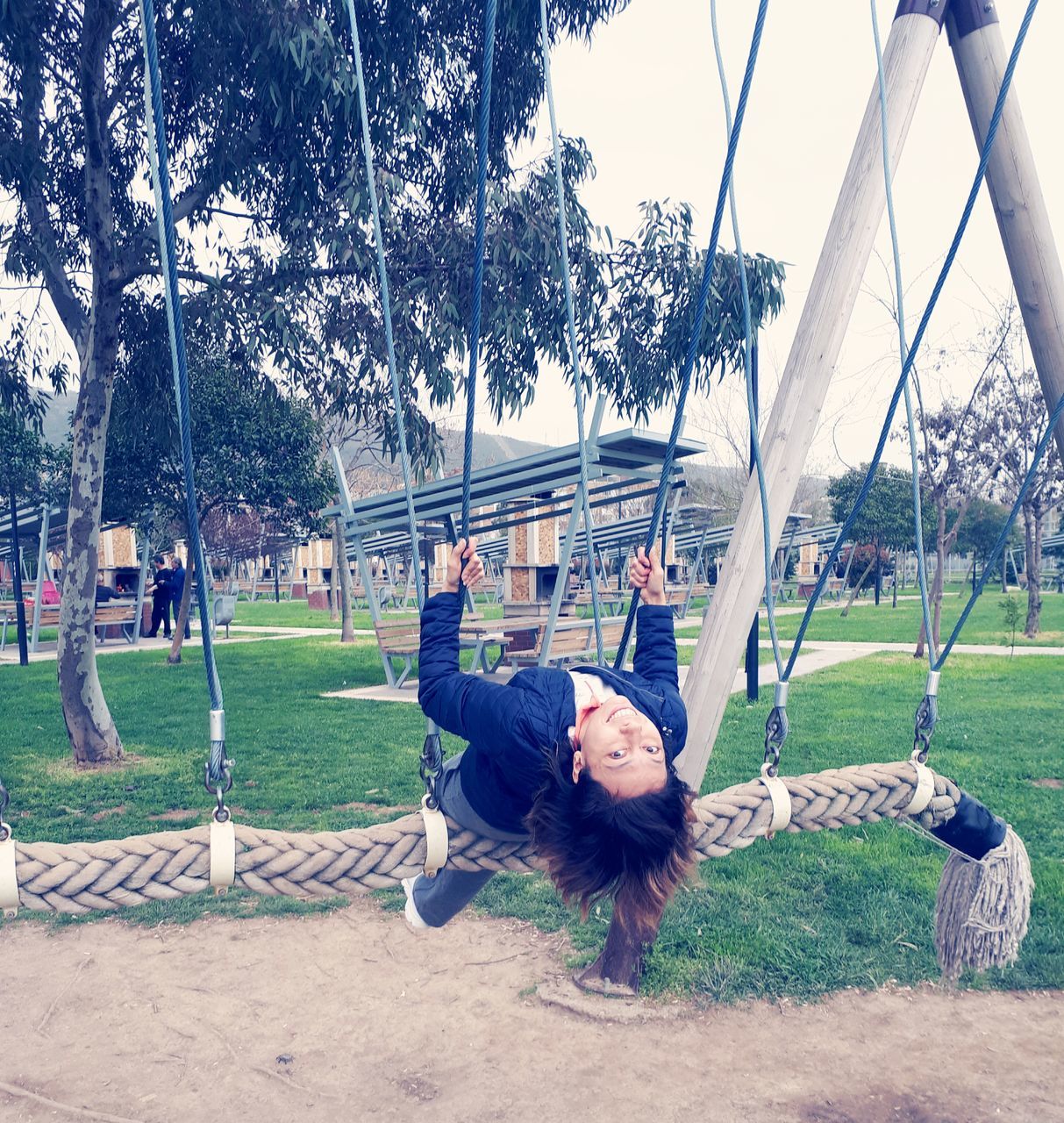 real people, tree, grass, day, lifestyles, leisure activity, field, outdoors, one person, park - man made space, swing, playing, childhood, nature, young adult, sky, people