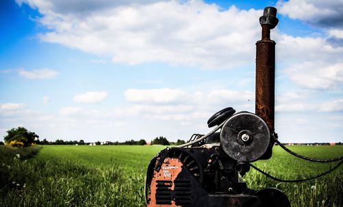 Tractor on agricultural field against sky